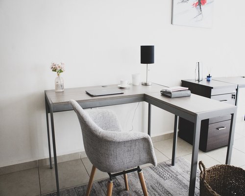 Organized desk with laptop and soft desk lamp lighting